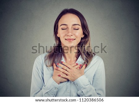 Imagine de stoc: Faithful Woman With Eyes Closed Keeps Hands On Chest Near Heart Shows Kindness