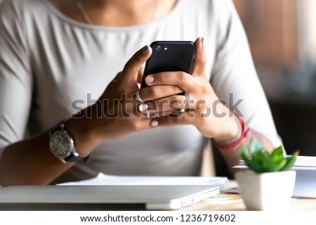 ストックフォト: Hand Of Young Woman Holding Smartphone Close To Electronic Payment Machine