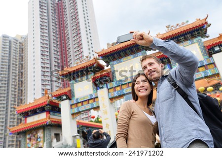 Stockfoto: Caucasian Couple In Hong Kong Young People Taking Selfie Picture At Viewpoint Of Famous Attraction