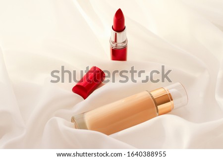 [[stock_photo]]: Beige Tonal Cream Bottle Make Up Fluid Foundation Base And Red L