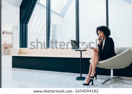 Сток-фото: Woman Economist Checks Information On Business Paper Wears Spectacles And Elegant Suit Drinks Milk