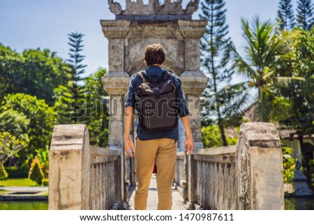 Zdjęcia stock: Young Man In Water Palace Soekasada Taman Ujung Ruins On Bali Island In Indonesia Amazing Old Archi