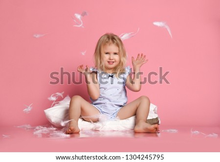 Stock photo: Naughty Small Kid With Blonde Hair And Blue Eyes Sits On Window Sill Looks Out Of Window Notices