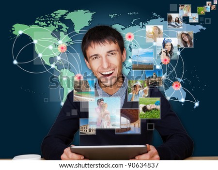 Stock photo: A Technology Man Has Images Flying Away From His Modern Tablet C