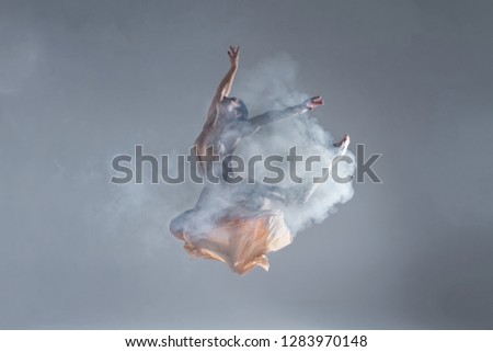ストックフォト: Young Beautiful Dancer In Beige Dress Dancing On Gray Background