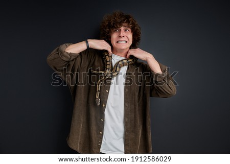 [[stock_photo]]: Beautiful Girl And The Snake Boa Constrictors Which Wraps Around Her Face