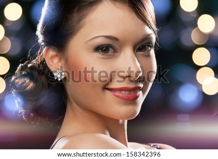 Foto stock: Beautiful Woman In Black Evening Dress Wearing Jewelry