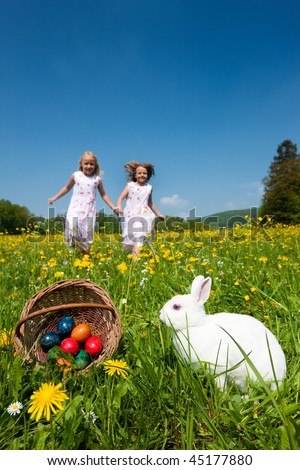 Stock foto: Easter Rabbit With Eggs In Front Of Blue Sky