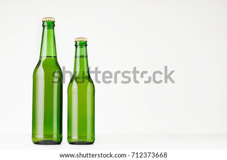 Stok fotoğraf: Green Longneck Beer Bottle 330ml With Blank White Label On White Wooden Board Mock Up Template For