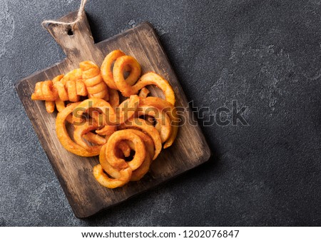 Foto stock: Curly Fries Fast Food Snack In Wooden Box On Stone Kitchen Background Unhealthy Junk Food