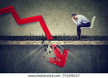 Foto stock: Stressed Businessman Looking Down At Falling Down Arrow Sitting Next To A Successful Guy Working On