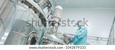 Stock fotó: Pharmaceutical Factory Woman Worker In Protective Clothing Operating Production Line In Sterile Envi