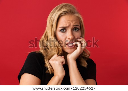 ストックフォト: Portrait Of Frightened Blond Woman 20s Frowning And Biting Nails