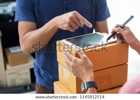 Сток-фото: Woman Courier Holding A Parcel Shipping Mail Appending Signature