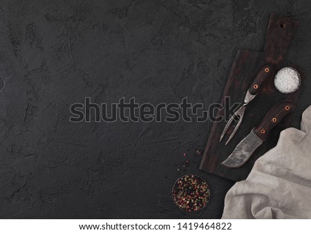 Foto d'archivio: Vintage Meat Knife And Fork And Hatchet On Black Table Background Butcher Utensils Space For Text