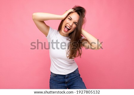 Zdjęcia stock: A Street Photo Of A Young Brunette Woman In A Blank White Background Is Looking Aside While Standing