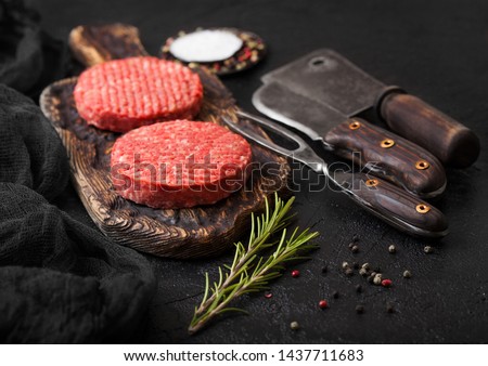 [[stock_photo]]: Fresh Raw Minced Pepper Beef Burgers On Vintage Chopping Board With Buns Onion And Tomatoes On Woode
