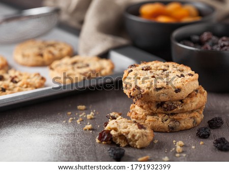 Сток-фото: Homemade Organic Oatmeal Cookies With Raisins And Apricots On Wooden Background Black Bowl Of Flour