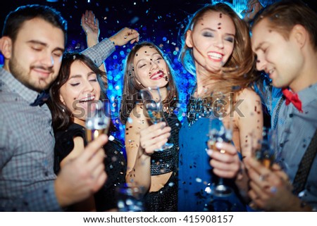 Foto stock: Pretty Young Glamorous Woman Cheering Up With Flute Of Champagne At Party