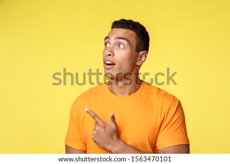 Stok fotoğraf: Surprised Handsome Masculine Young Hispanic Guy In Shirt Over T Shirt Showing Peace Or Quotation G