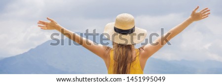 Stock foto: Woman Traveler Looking At Batur Volcano Indonesia Banner Long Format