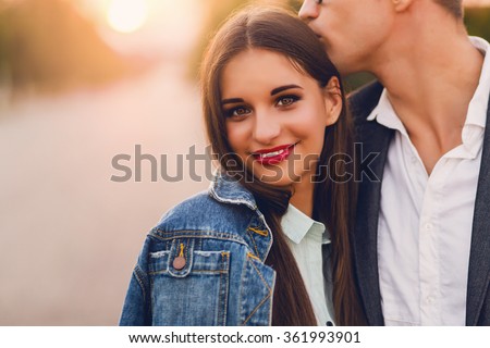 Stok fotoğraf: Attractive Young Girl Embracing Her Handsome Boyfriend On The Be