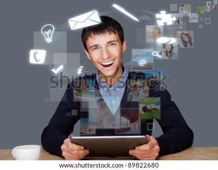 Stock photo: A Businessman With Icons Floating Around His Head Portrait Of H