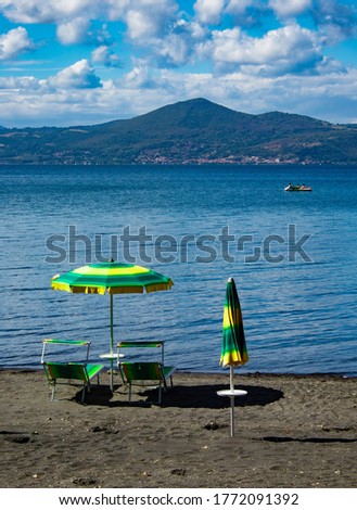 Foto stock: Different Parasols And Sun Loungers On The Empty Beach On Tavira