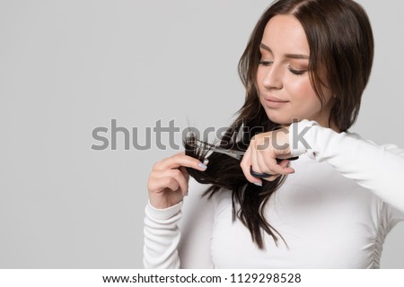 Stock fotó: Shocked Unhappy Woman Trimming Split Ends Of Hair With Scissors