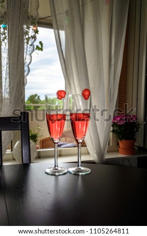 Stockfoto: Champagne White Rose And Red Wins And Drinks In Glasses On Stained Glass Background