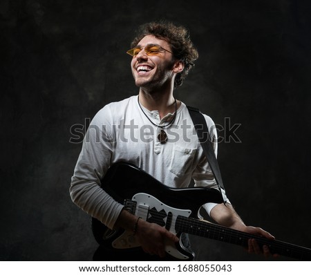 ストックフォト: Portrait Of Attractive Young Guitarist Wearing Shirt With Red Pl