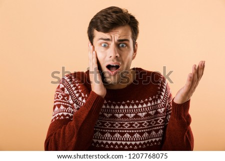 Foto d'archivio: Image Of Confused Man 20s With Stubble Wearing Knitted Sweater D