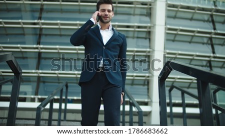 Stok fotoğraf: Handsome Business Man Near Business Center Using Mobile Phone
