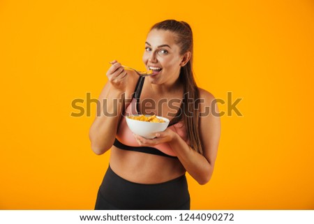 ストックフォト: Image Of Sportive Chubby Woman In Tracksuit Eating Corn Flakes W