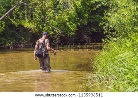 Stok fotoğraf: Man Fishing On A Mountain River With A Ultralight Spinning Using Fishing Wobblers He Got His Hook H