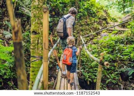 Stock photo: Father And Son Travelers On The Suspension Bridge In Bali Traveling With Children Concept