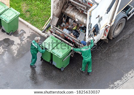 ストックフォト: Two Refuse Collection Workers Loading Garbage Into Waste Truck