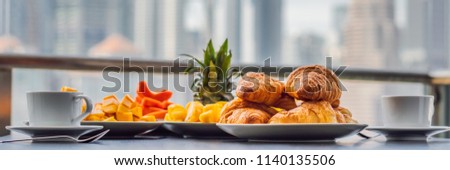 Stockfoto: Breakfast Table With Coffee Fruit And Bread Croisant On A Balcony Against The Backdrop Of The Big Ci