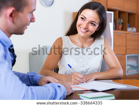 Stockfoto: Discussing Life Insurance Program With Agent