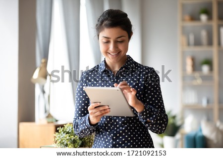 Stockfoto: Happy Girl Using Tablet To Search For Online Goods And Plastic Card For Payment