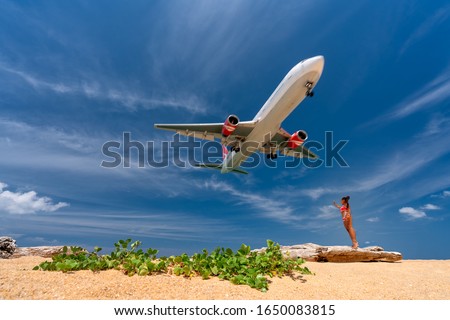 Foto stock: Woman Have Fun On The Beach Watching The Landing Planes Traveling On An Airplane Concept Text Spac