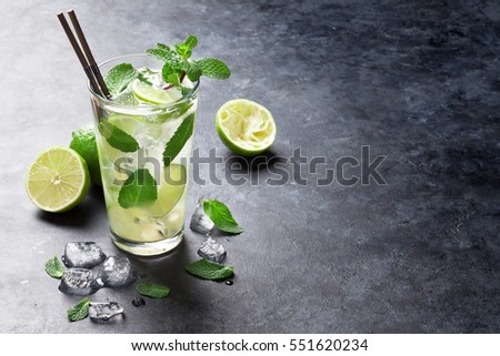 Stockfoto: Glass Of Mojito Cocktail With Ice Cubes Mint And Lime On Black Board With Spoon And Fresh Limes With