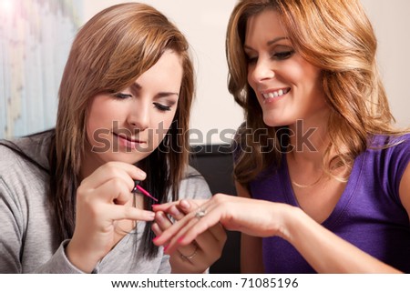 Stock foto: Horizontal Shot Of Pretty Young Mother And Daughter With Curlers On Hair Being In Good Mood Enjoy