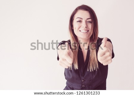 Stock foto: Good Looking Woman Having Her Thumb Up While Standing Against A White Background