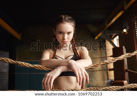 Foto stock: Close Up Portrait Of Concentrated Female Fighter Ready To Fight