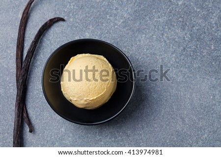 Stok fotoğraf: Vanilla Caramel Ice Cream In Black Bowl With Vanilla Pods Grey Stone Background