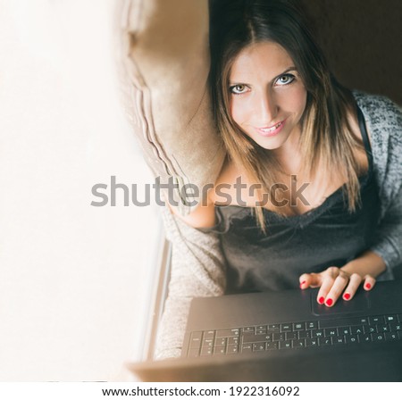 Foto stock: Portrait Of Relaxed Beautiful Caucasian Lady Has Blue Eyes Well Cared Skin Looks Directly At Camer