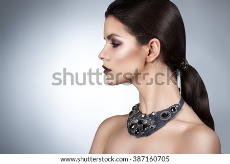 Foto stock: Beautiful Girl With Smoky Eyes And Red Lips Holding Cigarette