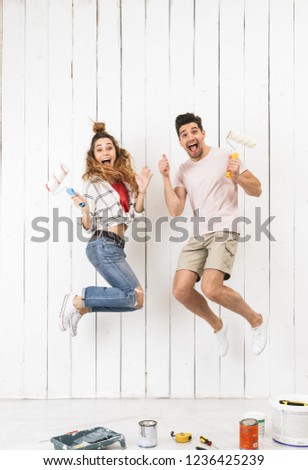 Stockfoto: Full Length Photo Of Loving Couple Man And Woman Painting White