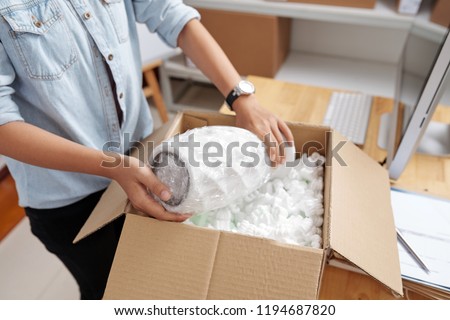 Foto stock: Woman Unpacking Vase